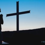 woman praying on knees