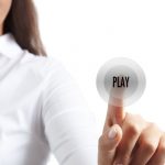 finger pushing "play" button
