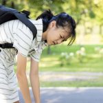 Woman carrying heavy backpack