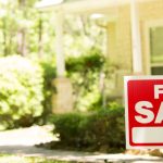 For Sale sign in front of house